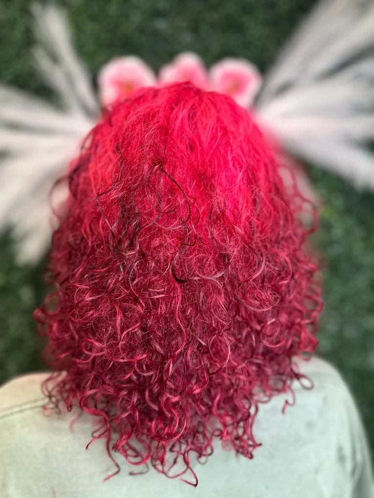 Vibrant red curly hair color result at Caribbean Queen Beauty Salon in Charlotte NC