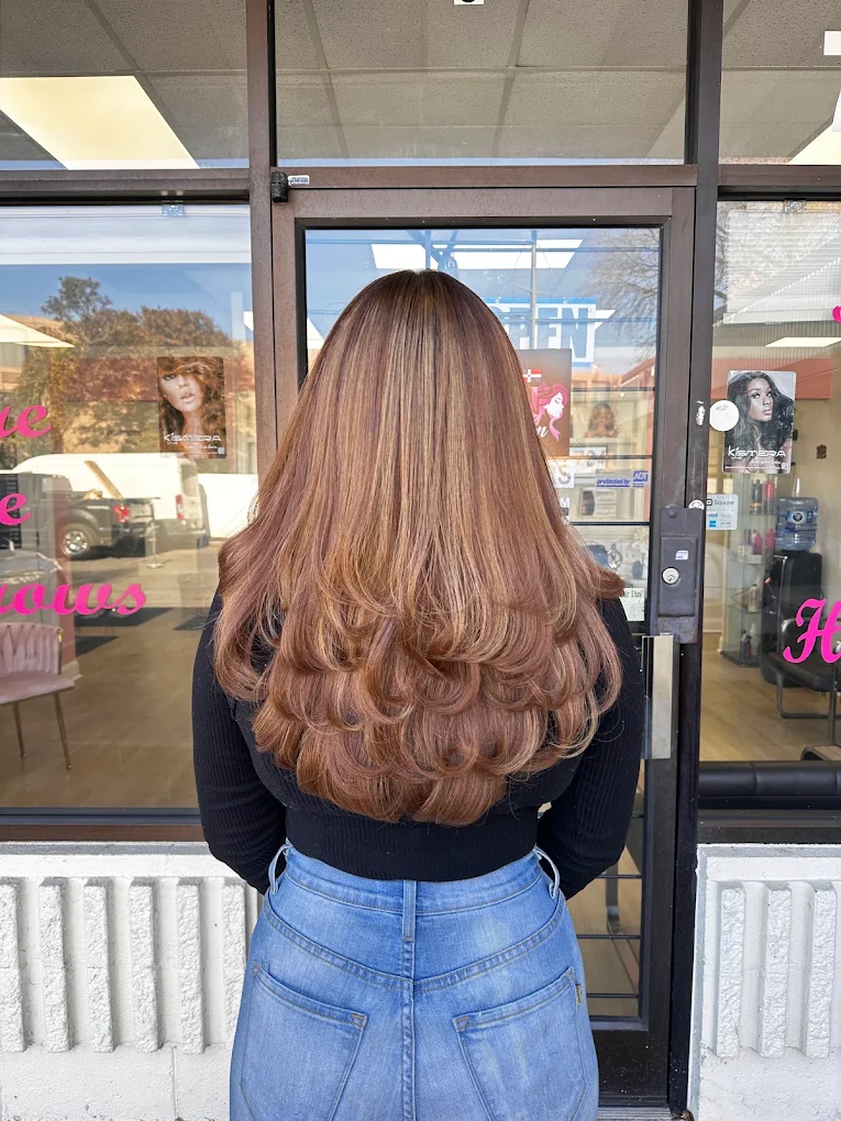 Auburn layered blowout with bouncy curls at a Dominican salon in Charlotte NC