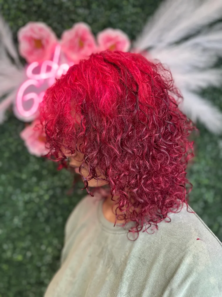 Bold magenta curly hair color at Caribbean Queen, Charlotte NC